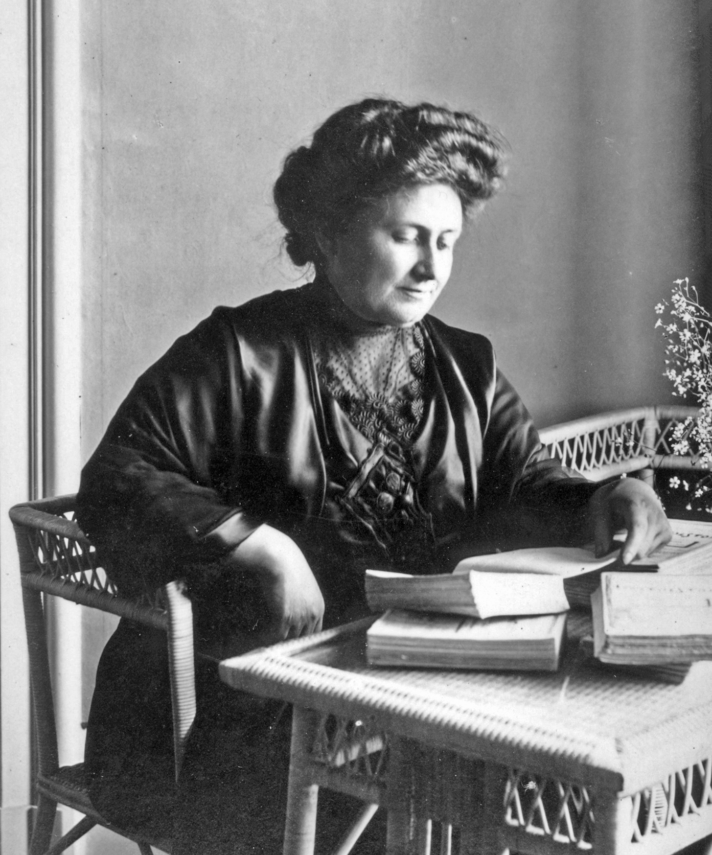 Dr. Maria Montessori in a 1913 portrait photograph with a book