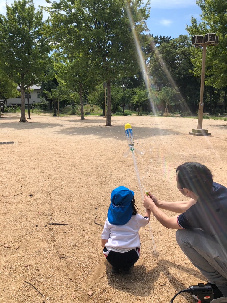 Students launching a water rocket during an outdoor science activity