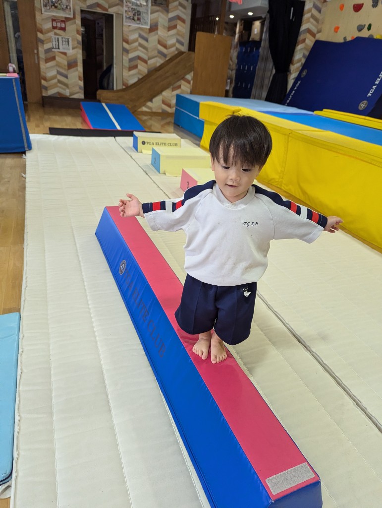 Student practicing on the gymnastics bar