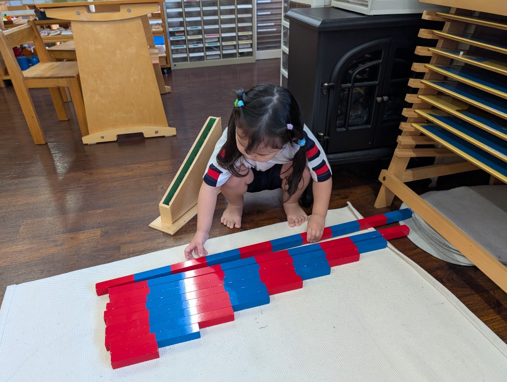 Student working with Montessori math materials