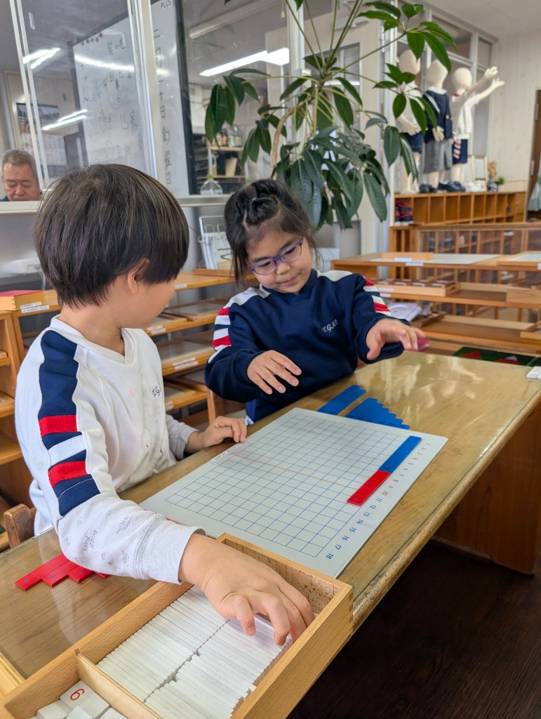 Student working with Montessori math materials
