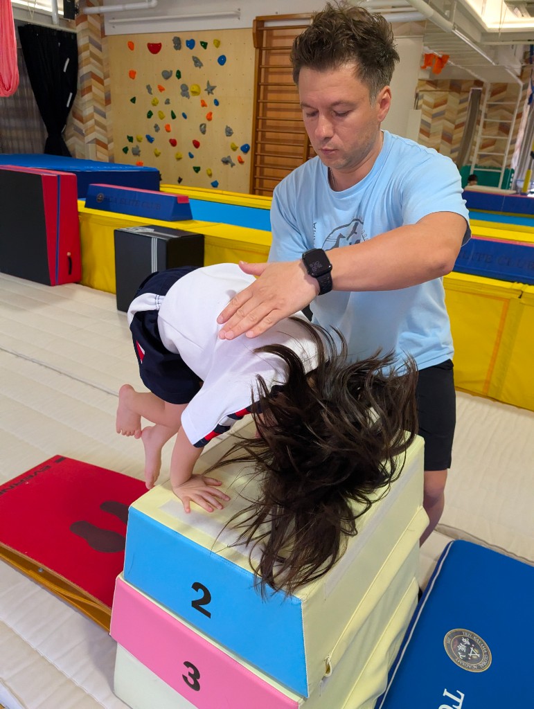 Student practicing on the gymnastics bar