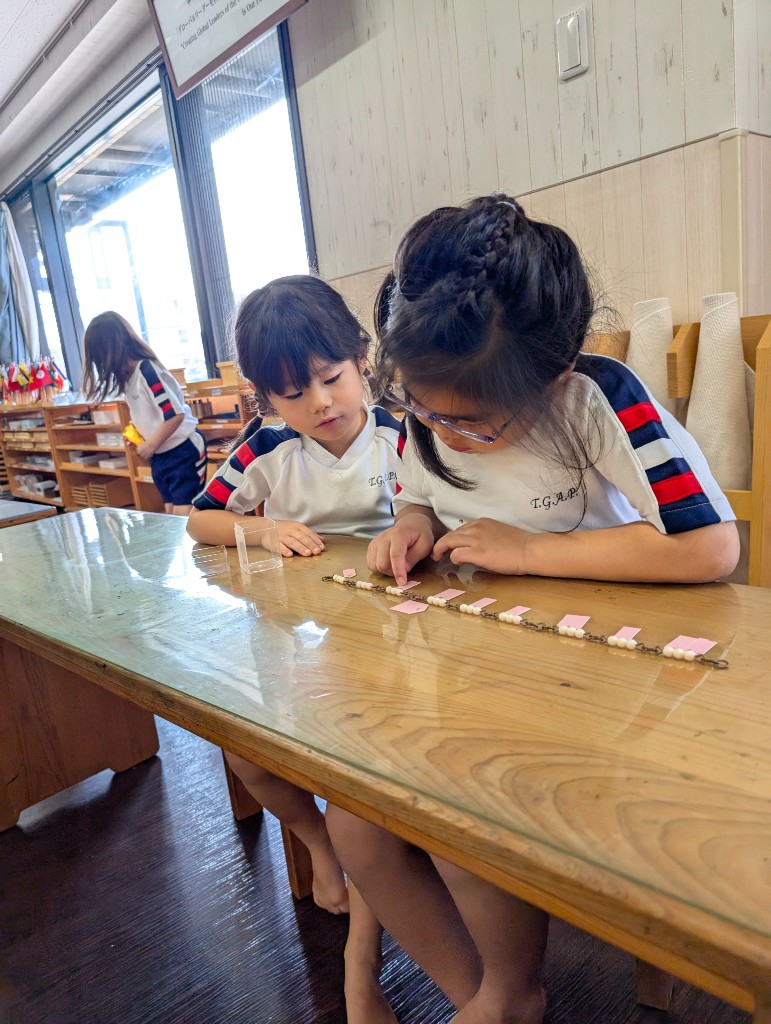 Child working with Montessori bead chains
