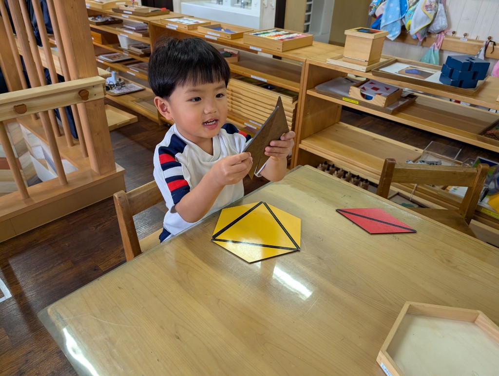 Student working with Montessori math materials