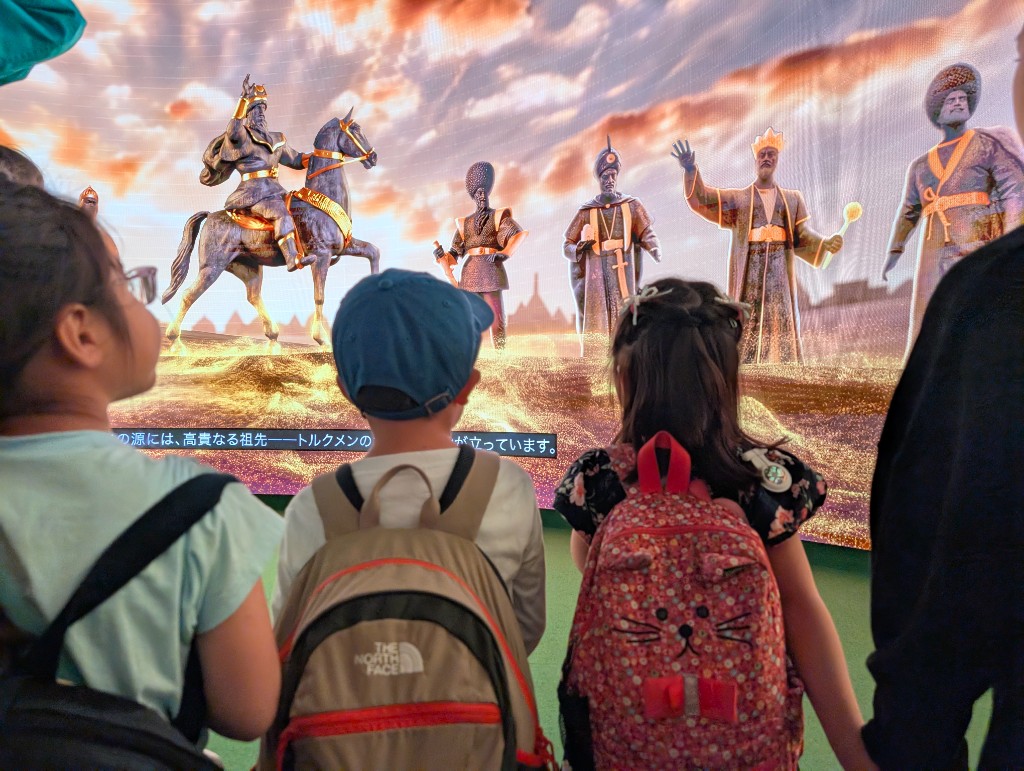 TGA students on a field trip viewing a large historical exhibit display