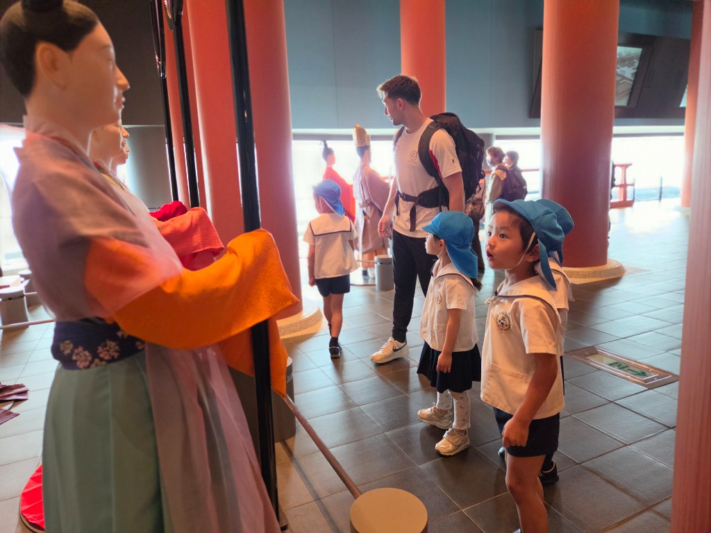 TGA students in school uniforms exploring historical exhibits at the Osaka Museum of History with their teacher