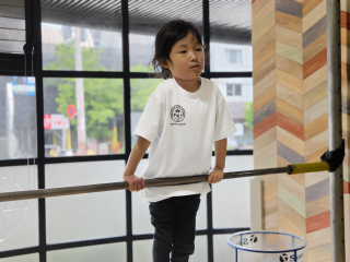 Student practicing on the gymnastics bar