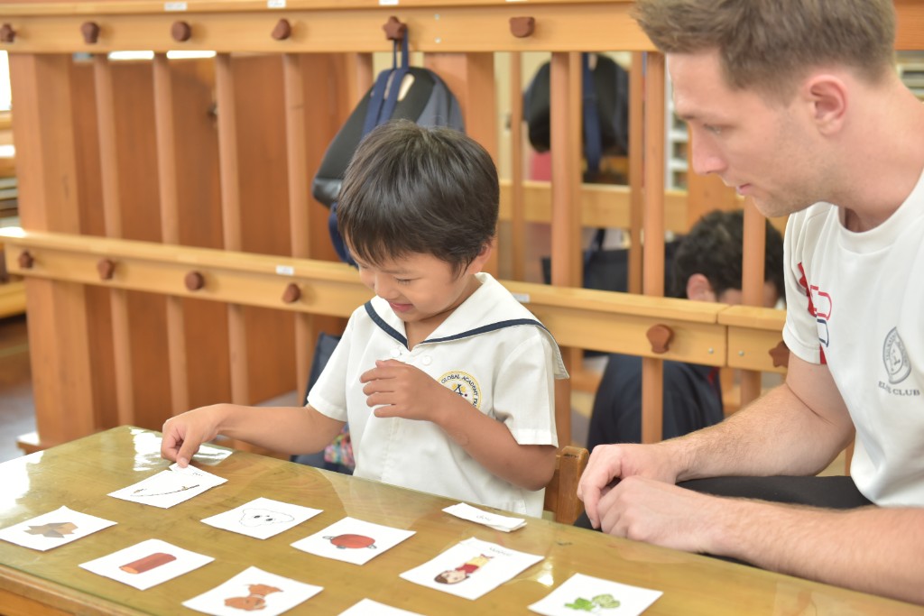 Student and teacher working together with literacy flashcards