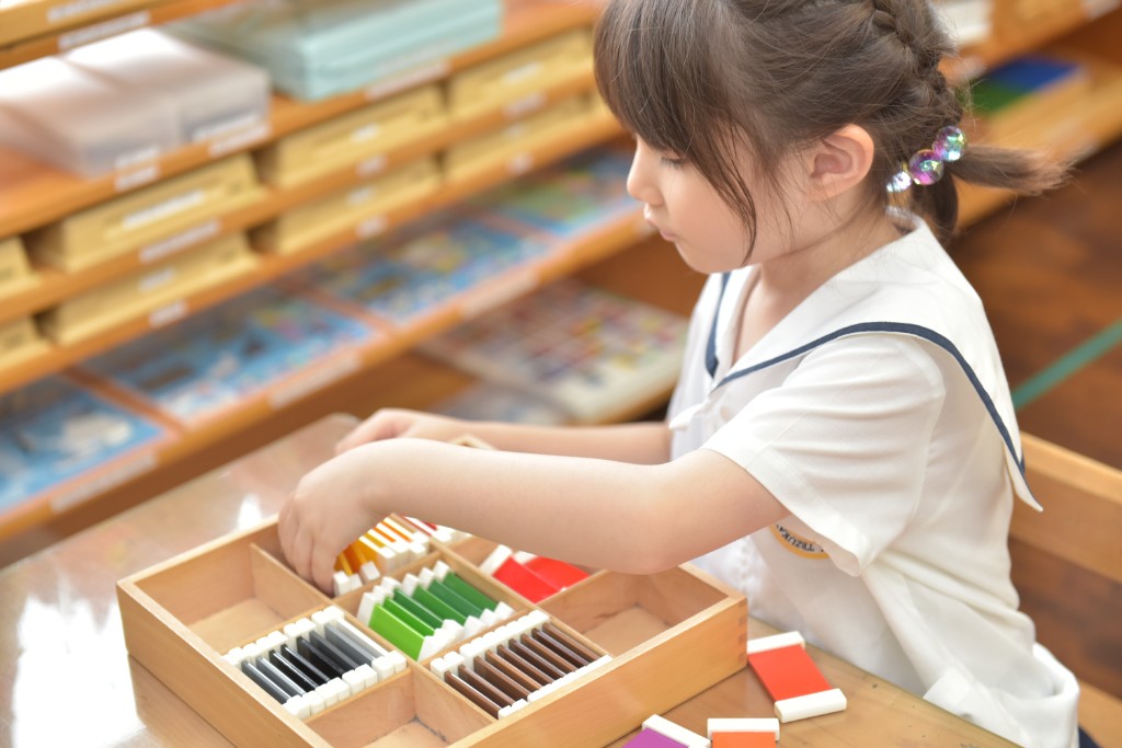 Student working with Montessori color discrimination tablets
