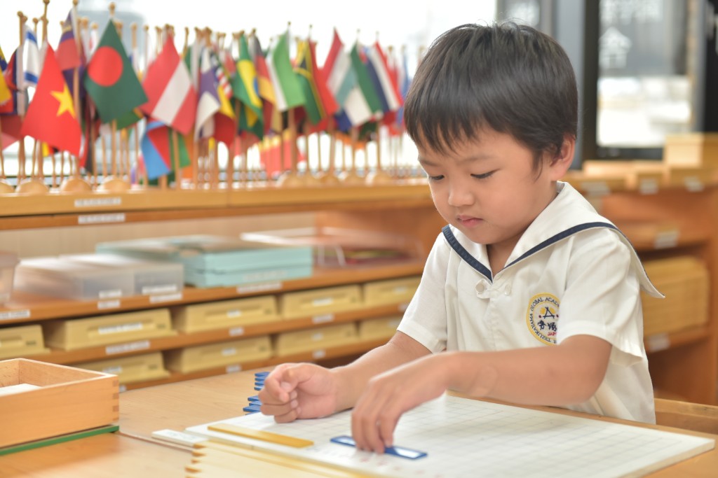 Student working with Montessori math materials