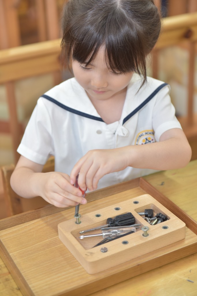 Student practising practical life skills with Montessori tools